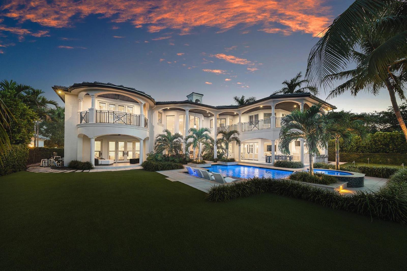 A two-story white house with a pool, patio, and palm trees at sunset — 121 Royal Palm Way, Boca Raton FL 33432, BOCA RATON, FL