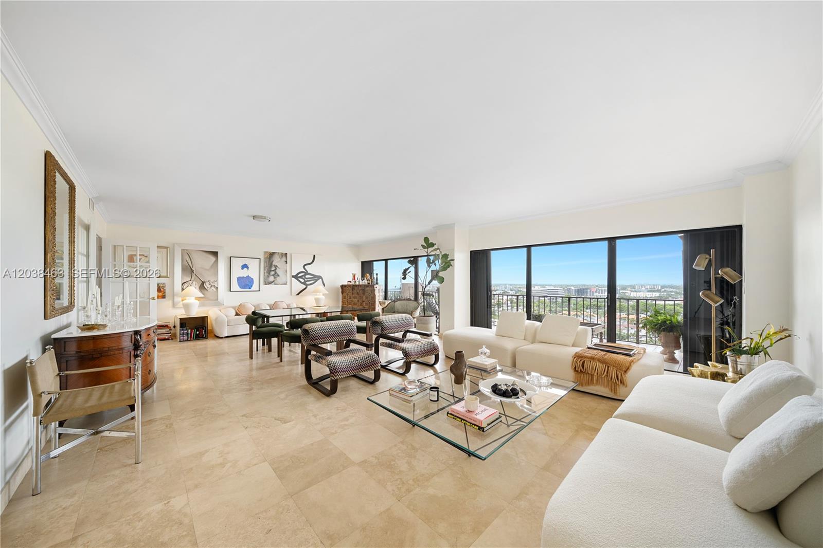 A spacious, open-concept living and dining area features tile floors, modern furniture, and floor-to-ceiling windows — 1800 NE 114th St # 1811, Miami FL 33181, MIAMI, FL