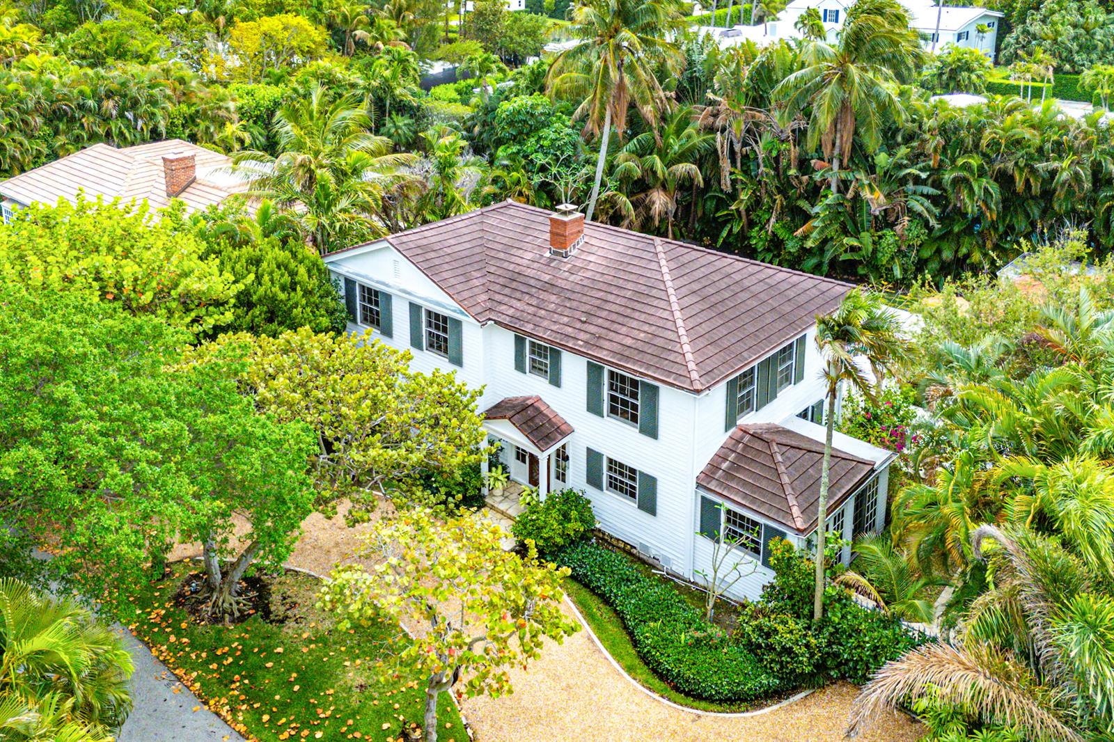 An aerial view of a two-story white house with a brown tile roof and shutters — 210 Merrain Road, Palm Beach FL 33480, PALM BEACH, FL