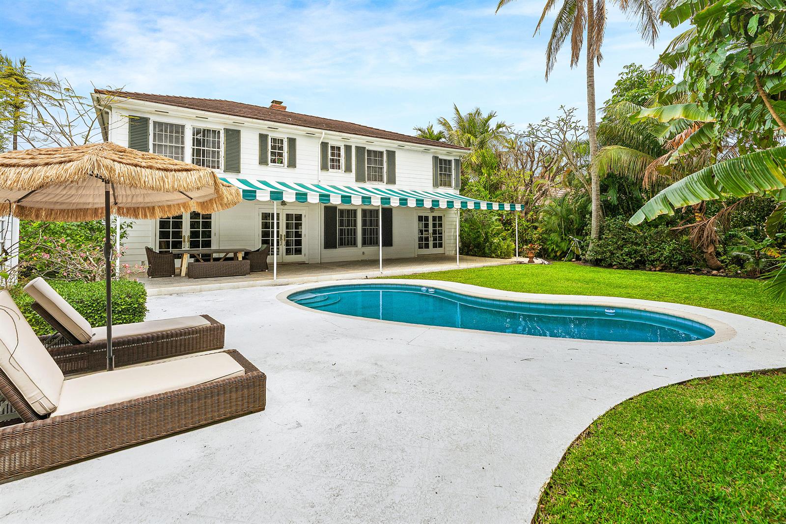 A two-story white house with a pool, patio, and lounge chairs in the backyard — 210 Merrain Road, Palm Beach FL 33480, PALM BEACH, FL