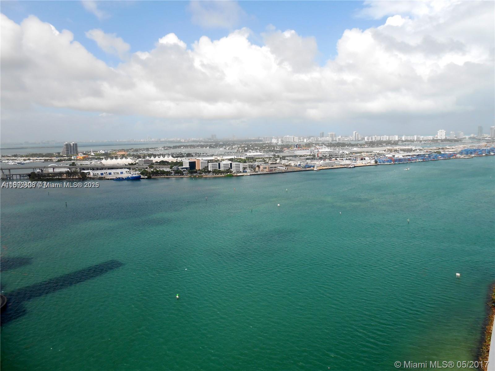 An aerial view shows the Port of Miami with cruise ships and city buildings — 900 Brickell Key Blvd # 2602, Miami FL 33131, MIAMI, FL