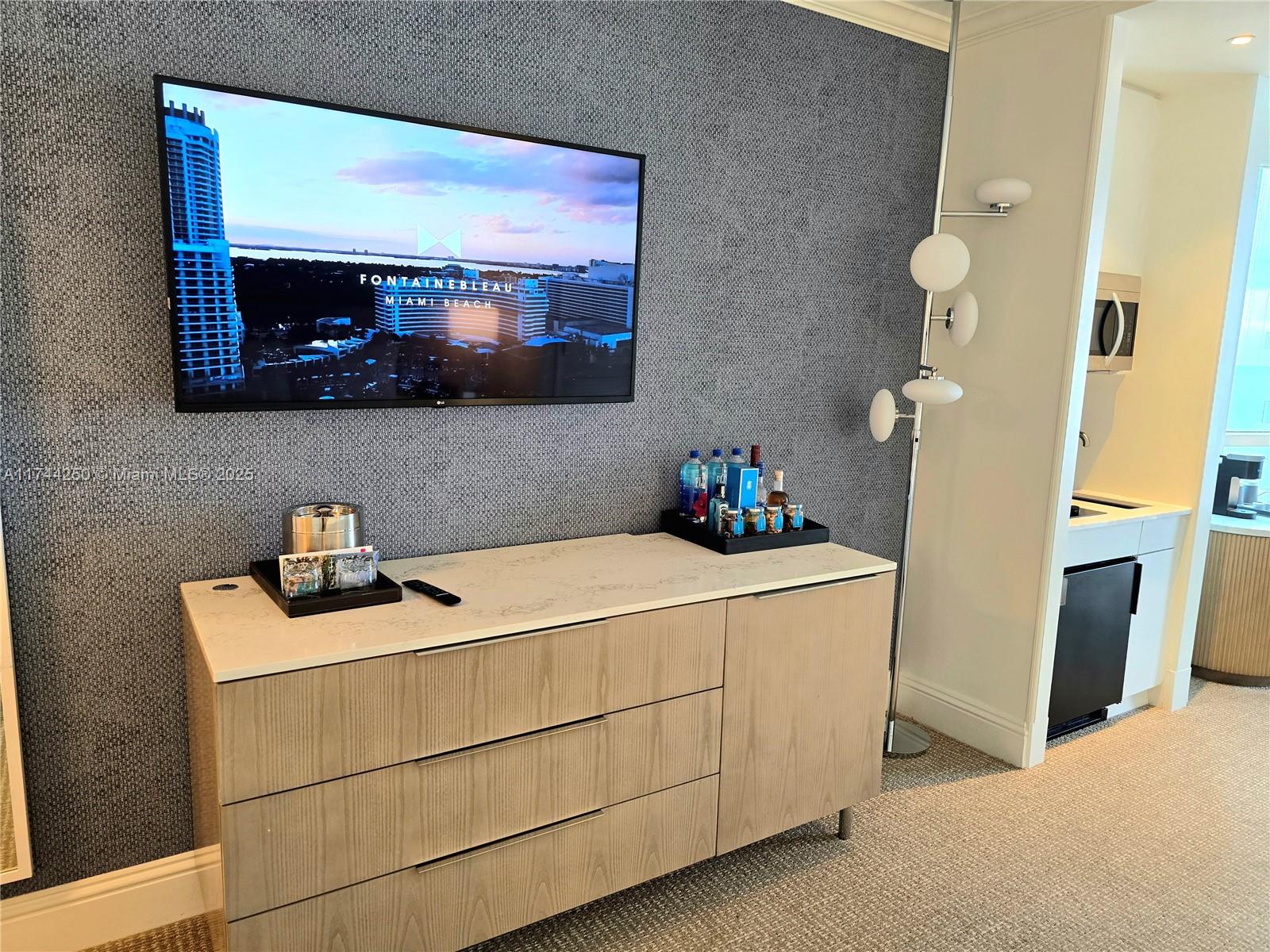 A hotel-style bedroom features a large bed, a kitchenette, and a balcony with ocean views — 4401 Collins Ave # 1401, Miami Beach FL 33140, MIAMI BEACH, FL