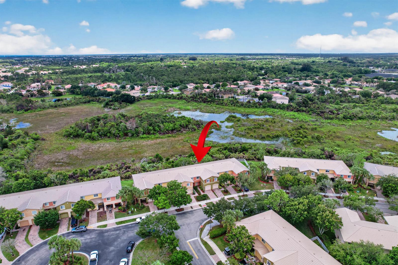 An aerial view shows a multi-unit residential building with a red arrow pointing toward it — 5313 SE Jennings Lane, Stuart FL 34997, STUART, FL