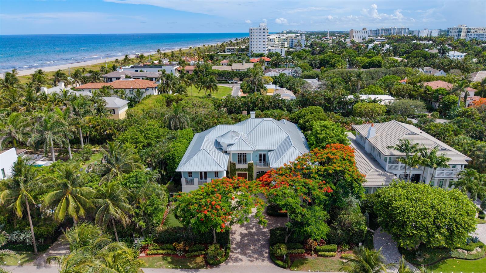 An aerial view of a coastal home with a metal roof surrounded by lush trees — 1232 Seaspray Avenue, Delray Beach FL 33483, DELRAY BEACH, FL