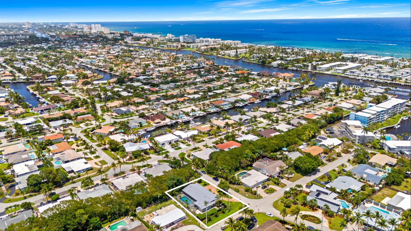 An aerial view of a coastal neighborhood featuring a highlighted house with a swimming pool — 2811 NE 53rd Court, Lighthouse Point FL 33064, LIGHTHOUSE POINT, FL
