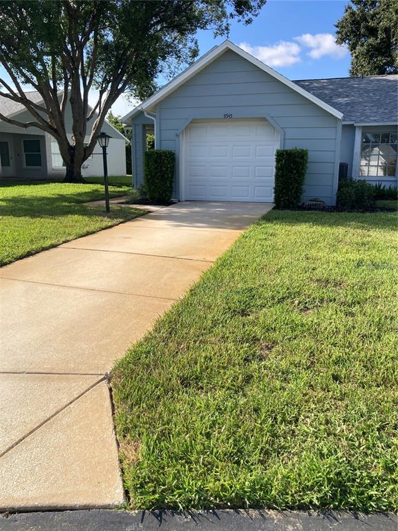 A light blue house with a single-car garage and a concrete driveway — 9545 DANVILLE COURT UNIT 42, NEW PORT RICHEY, FL