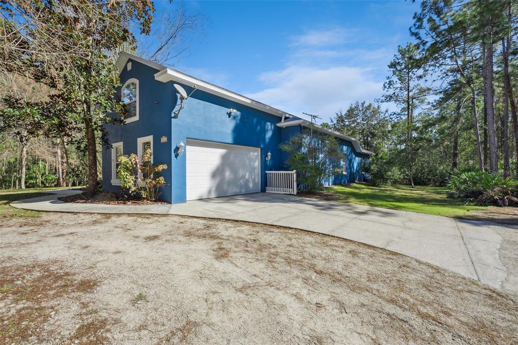 An aerial view of a blue house with a swimming pool and fenced backyard — 3441 HICKORY CREEK ROAD, DELTONA, FL