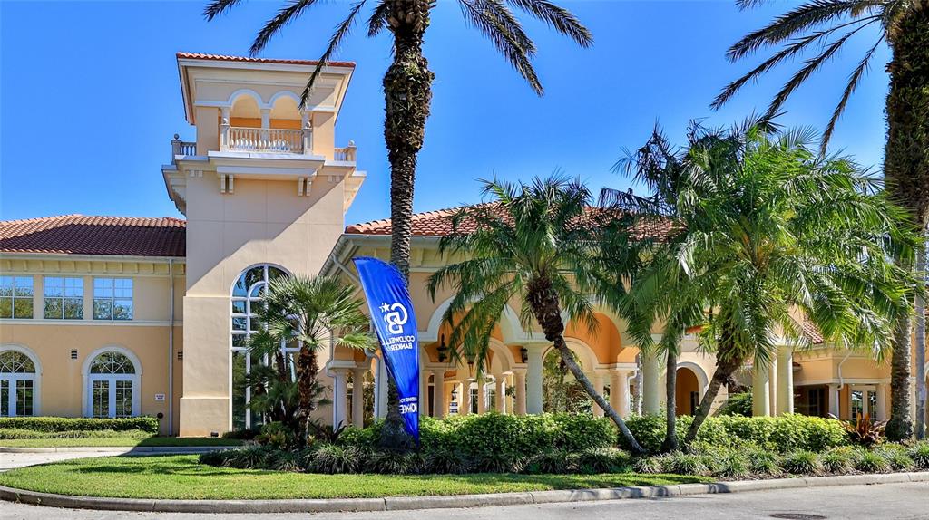 The exterior of a beige building features a tall tower, arched windows, and palm trees — 1 HAMMOCK BEACH PARKWAY, PALM COAST, FL