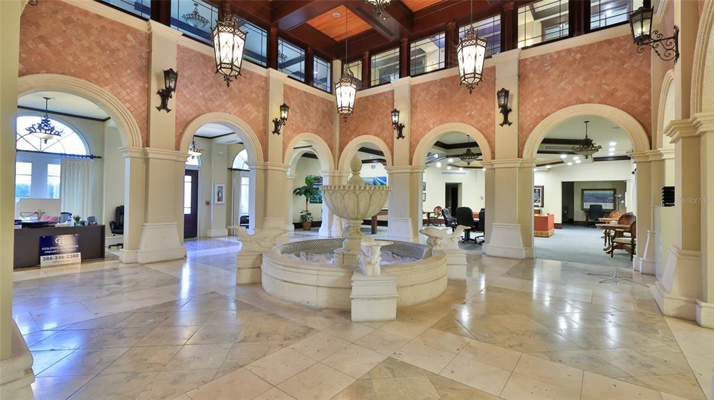 A grand lobby features a central stone fountain, arched doorways, and decorative hanging lanterns — 1 HAMMOCK BEACH PARKWAY, PALM COAST, FL