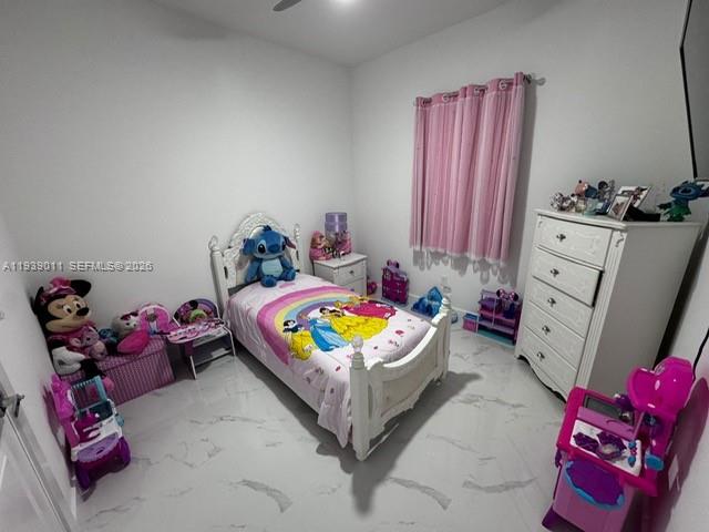 A child's bedroom features a white bed, a dresser, and pink curtains — 11 Connecticut Rd, Lehigh Acres FL 33936, LEHIGH ACRES, FL