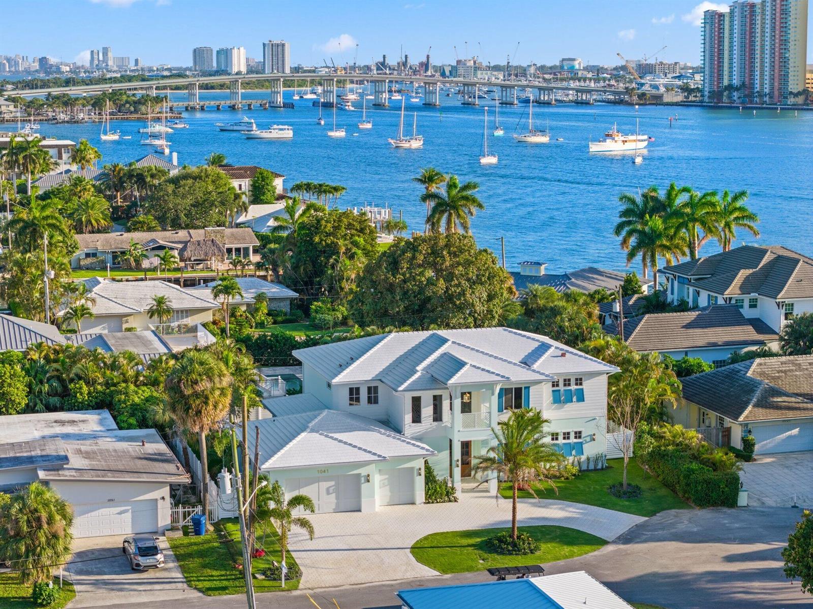 An aerial view of a two-story white house with a metal roof near the water — 1041 Bimini Lane, West Palm Beach FL 33404, WEST PALM BEACH, FL