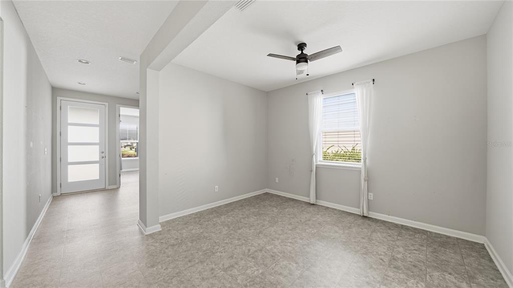 A room with light gray walls, tile flooring, a ceiling fan, and a window — 1937 AMBERLY DRIVE, MIDDLEBURG, FL