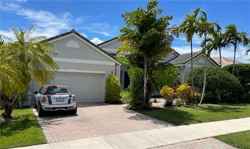 A light-colored single-story house features a two-car garage, a paved driveway, and palm trees — 2721 W Abiaca Circle, Davie FL 33328, DAVIE, FL