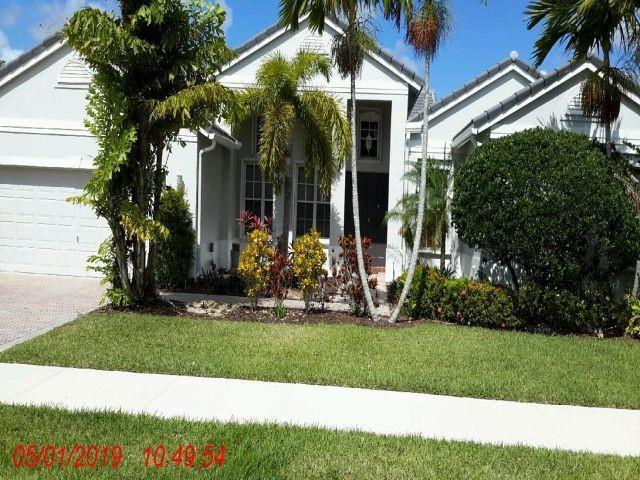 A single-story suburban house features a white exterior, a two-car garage, and palm trees — 2721 W Abiaca Circle, Davie FL 33328, DAVIE, FL