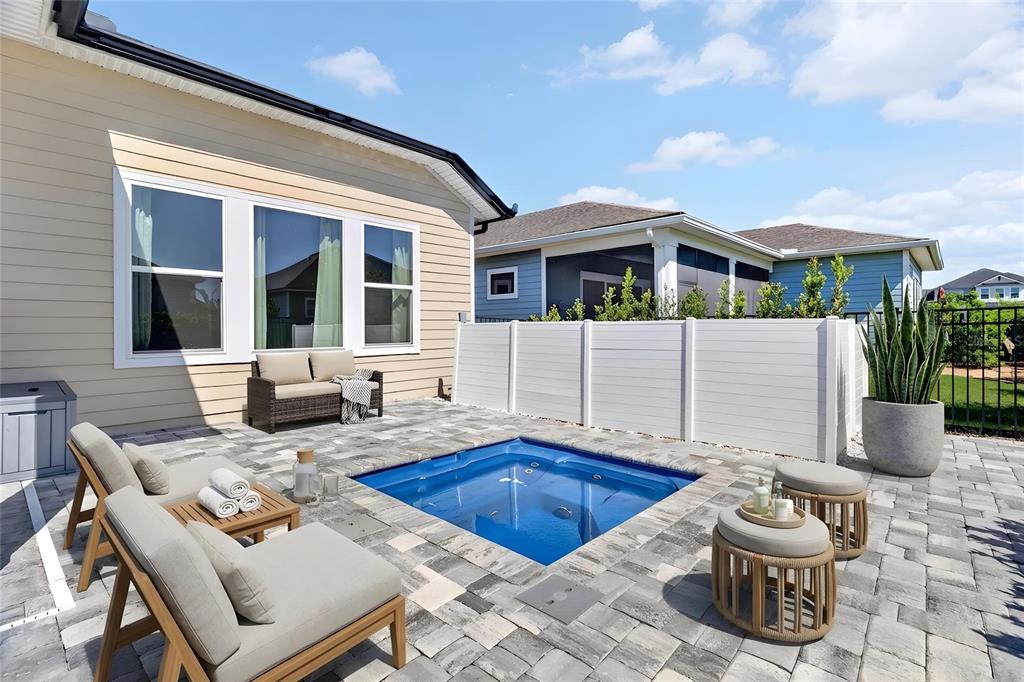A patio features a small rectangular pool, outdoor seating, and a white privacy fence — 3289 SW 120TH TERRACE, GAINESVILLE, FL