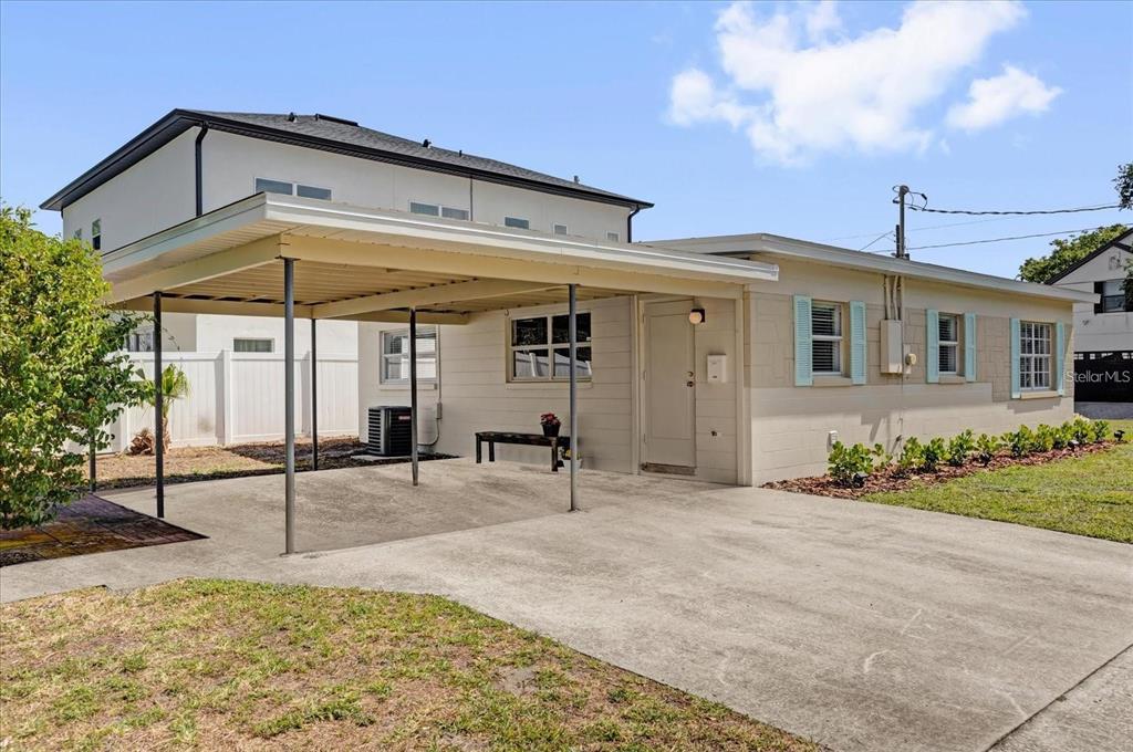 A single-story house with a carport and light-colored siding under a bright blue sky — 1600 HART LANE, ORLANDO, FL