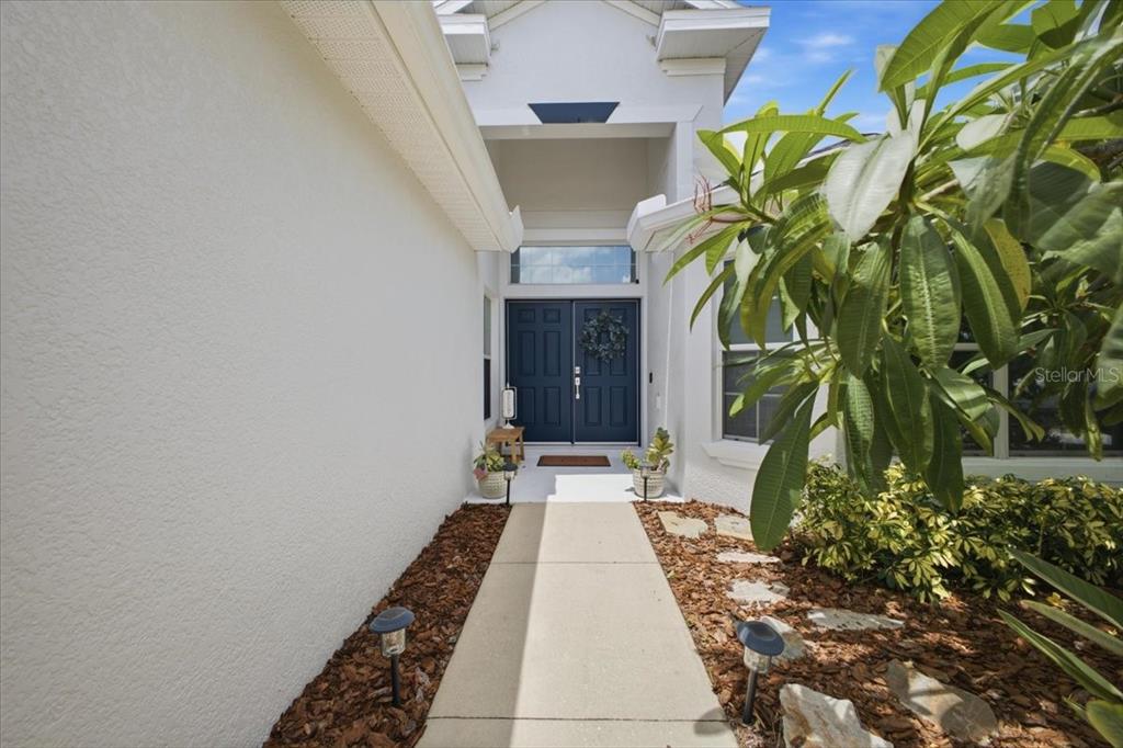 A living room features a large sectional sofa, a television, and an open kitchen area — 4708 TILDEN PARK COURT, BRADENTON, FL