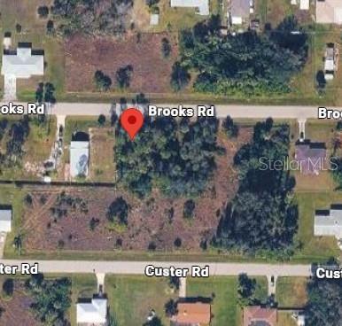 This is an aerial map view of a vacant, wooded residential lot between two roads — 26469 BROOKS ROAD, PUNTA GORDA, FL