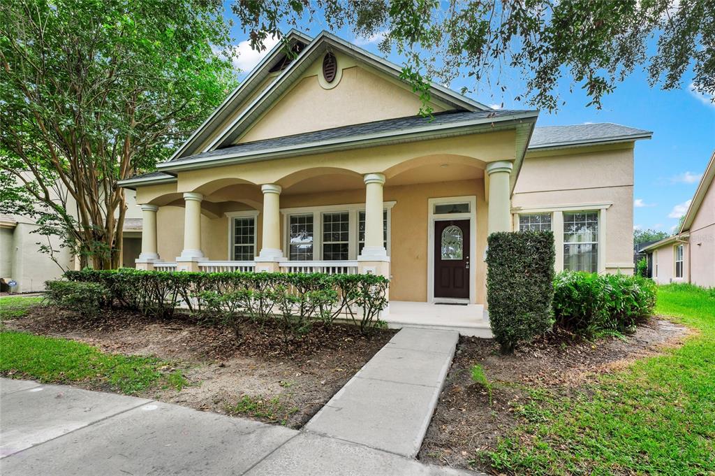 A single-story house with a covered front porch, columns, and a concrete walkway — 12718 BIDEFORD AVENUE, WINDERMERE, FL
