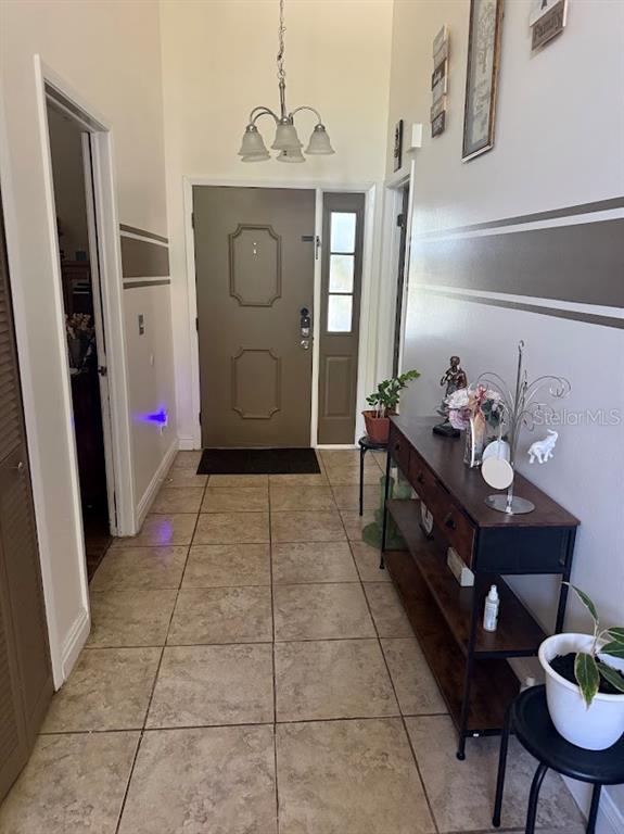 An entryway features tile flooring, a brown front door, and a console table — 2514 ABBEY AVENUE, ORLANDO, FL