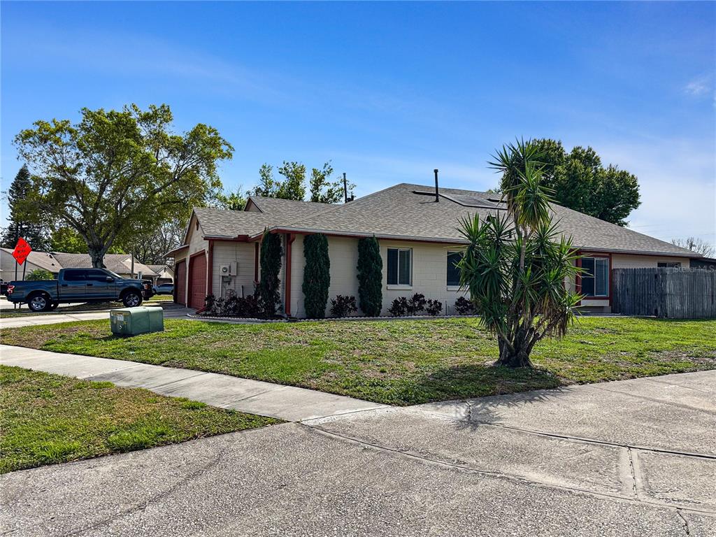 A single-story house with a beige exterior, red trim, and a palm tree in the yard — 2506 TOBIN COURT, ORLANDO, FL