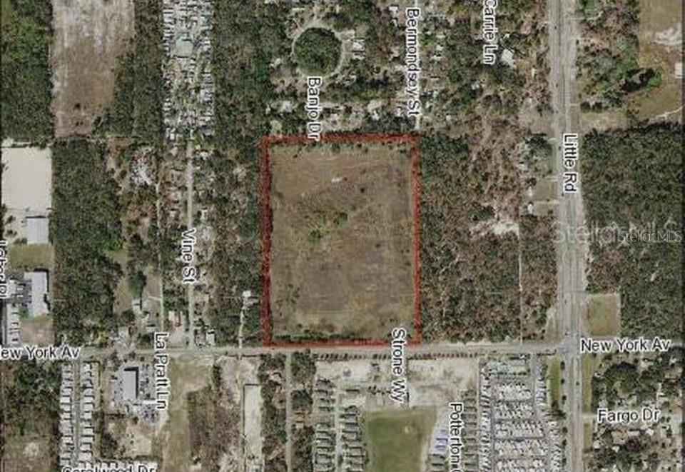 This is an aerial map showing a rectangular plot of land outlined in red — 9221 NEW YORK AVENUE, HUDSON, FL