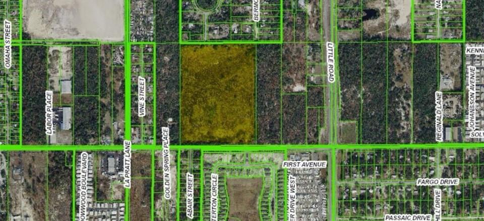 This is an aerial map showing a highlighted parcel of land surrounded by residential streets — 9221 NEW YORK AVENUE, HUDSON, FL
