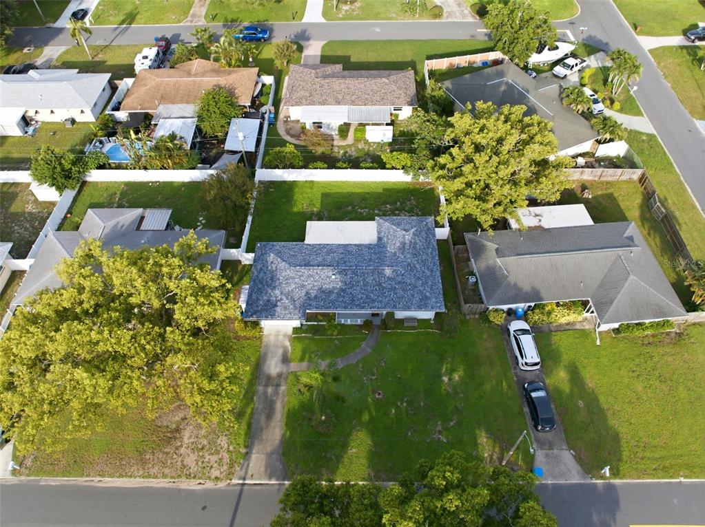 An aerial view shows several suburban houses with driveways, lawns, and mature trees — 8835 109TH STREET, SEMINOLE, FL