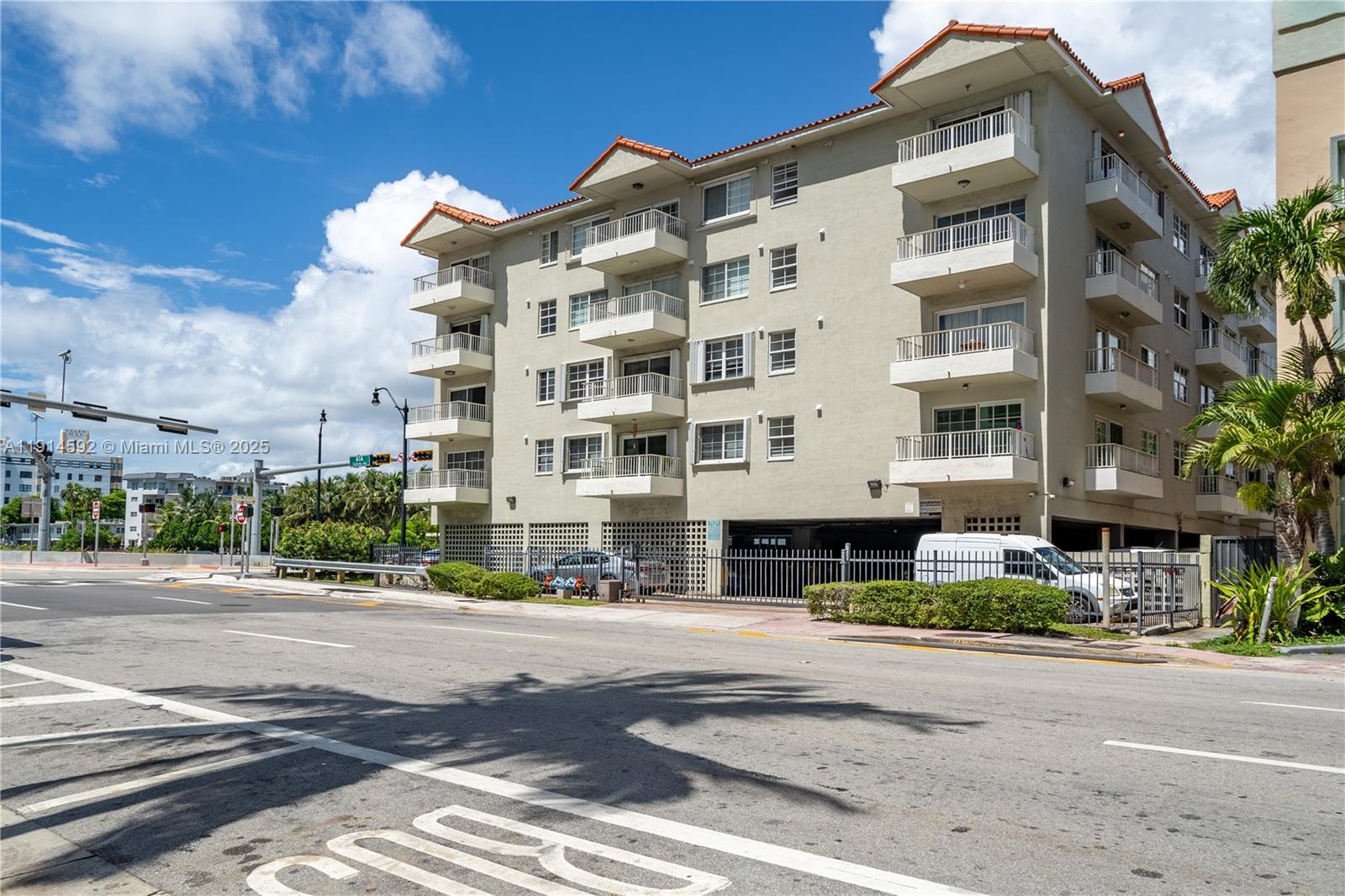 A multi-story apartment building with balconies stands next to a street with a crosswalk — 2600 Collins Ave # 308, Miami Beach FL 33140, MIAMI BEACH, FL