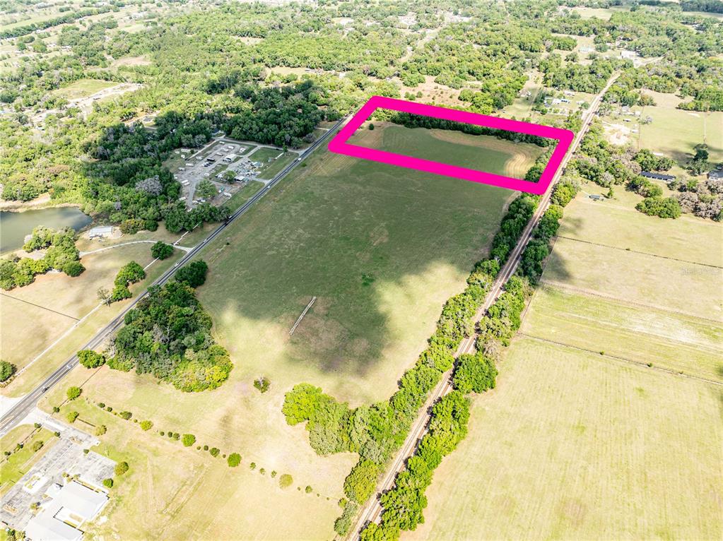 An aerial view shows a large, rectangular plot of land outlined in pink — 0000 S US HIGHWAY 301 HIGHWAY, SUMMERFIELD, FL
