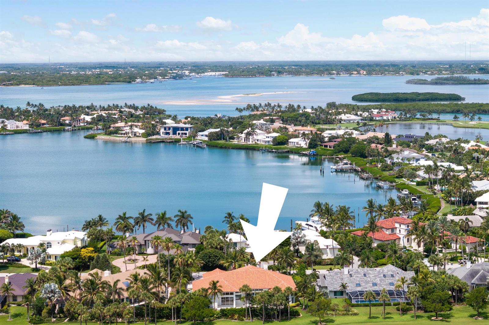 An aerial view shows a waterfront house with a terracotta roof and surrounding palm trees — 6841 SE Harbor Circle, Stuart FL 34996, STUART, FL