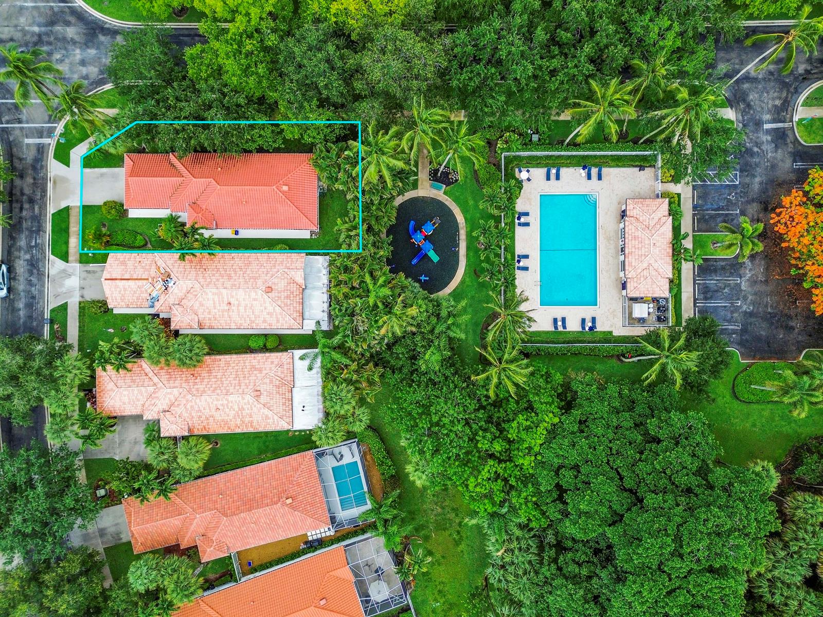 An aerial view shows a residential house with a red tile roof near a pool — 4766 Valencia Drive, Delray Beach FL 33445, DELRAY BEACH, FL