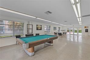 A bright recreation room features a pool table, tile flooring, and large windows — 4500 N Federal Highway # 153, Lighthouse Point FL 33064, LIGHTHOUSE POINT, FL