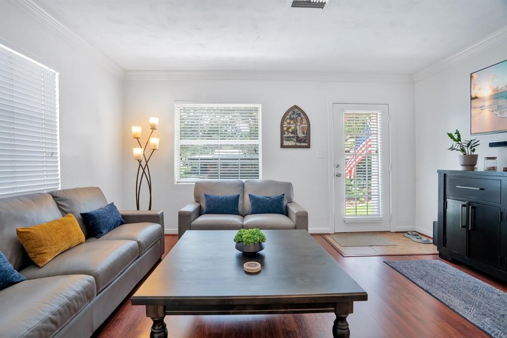 A living room features two gray sofas, a dark coffee table, and a glass door — 607 KERNEYWOOD STREET, LAKELAND, FL