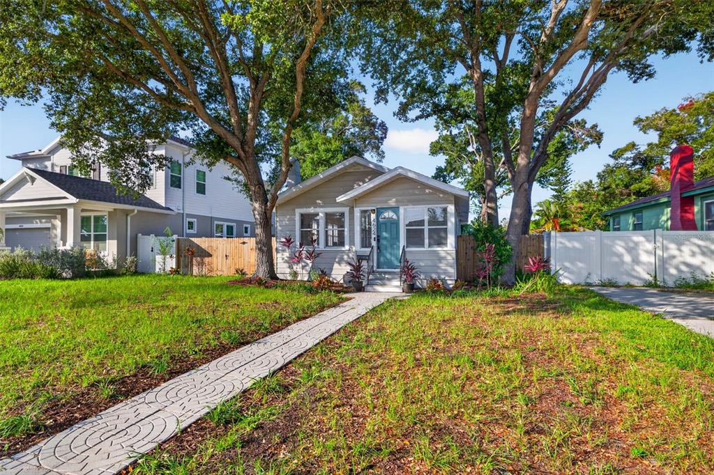 A single-story house with a teal front door and a decorative stone walkway in front — 4624 IRIS STREET N, ST PETERSBURG, FL