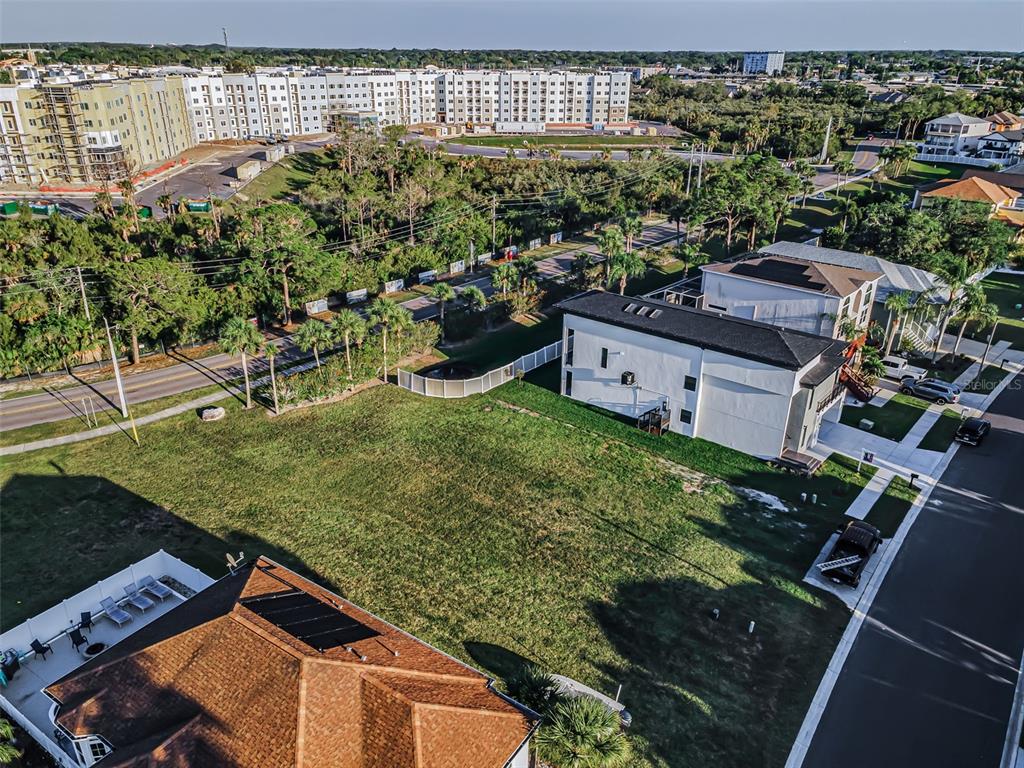 An aerial view shows a vacant grassy lot situated between two residential houses — Lot 59 JOBETH DRIVE, NEW PORT RICHEY, FL