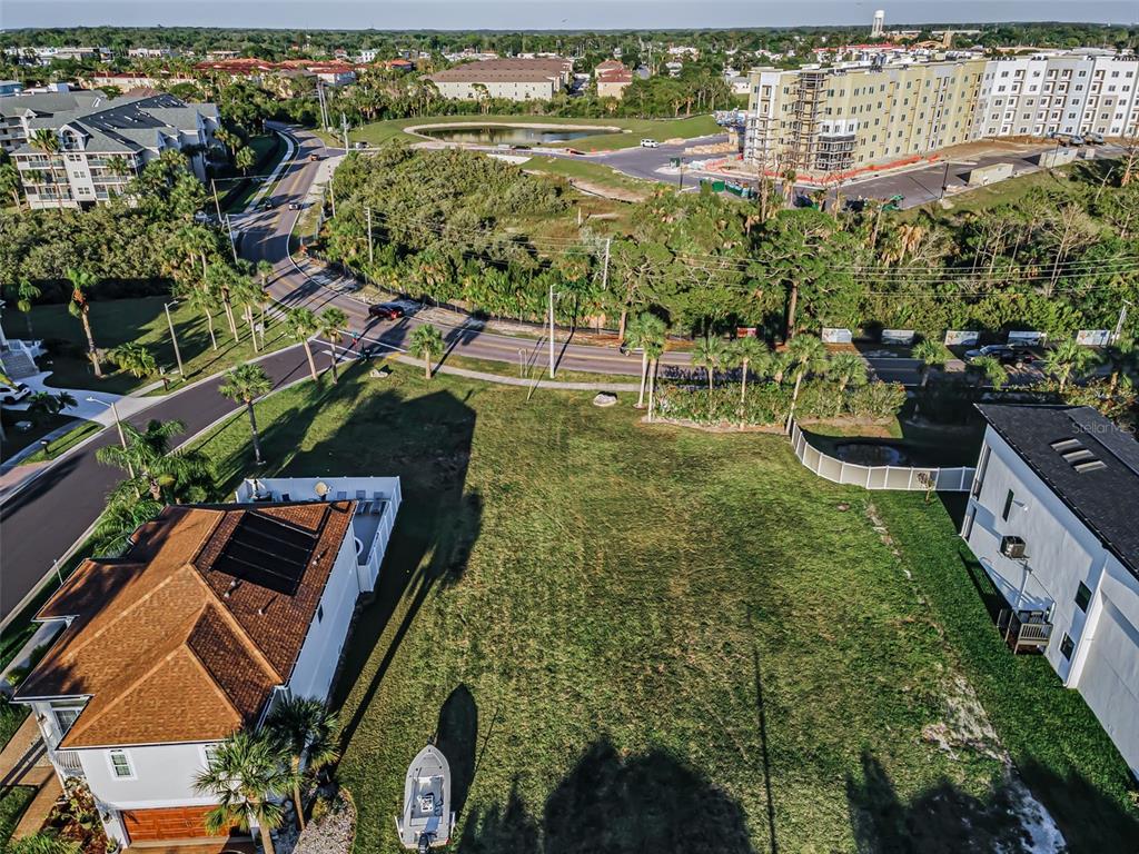 An aerial view shows a vacant grassy lot situated between two houses near a road — Lot 59 JOBETH DRIVE, NEW PORT RICHEY, FL