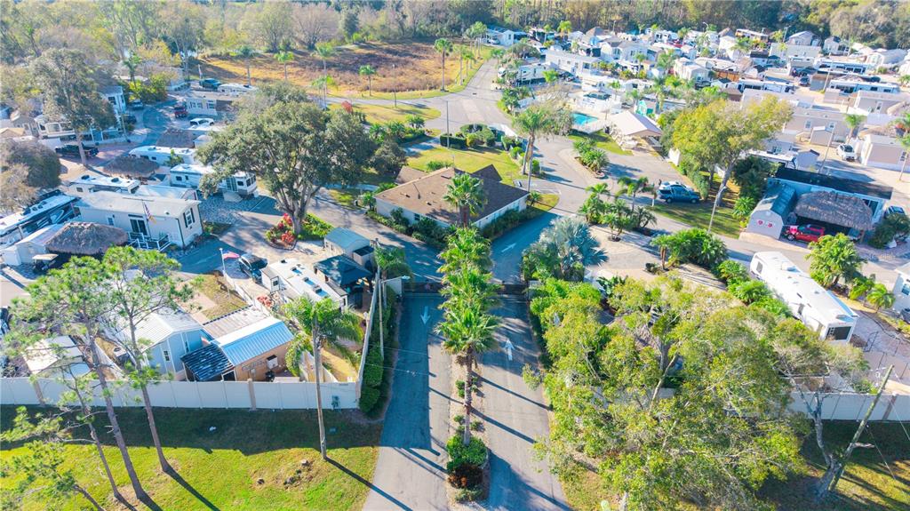 An aerial view shows a residential mobile home park with paved roads and palm trees — 20300 LEONARD ROAD UNIT 78, LUTZ, FL