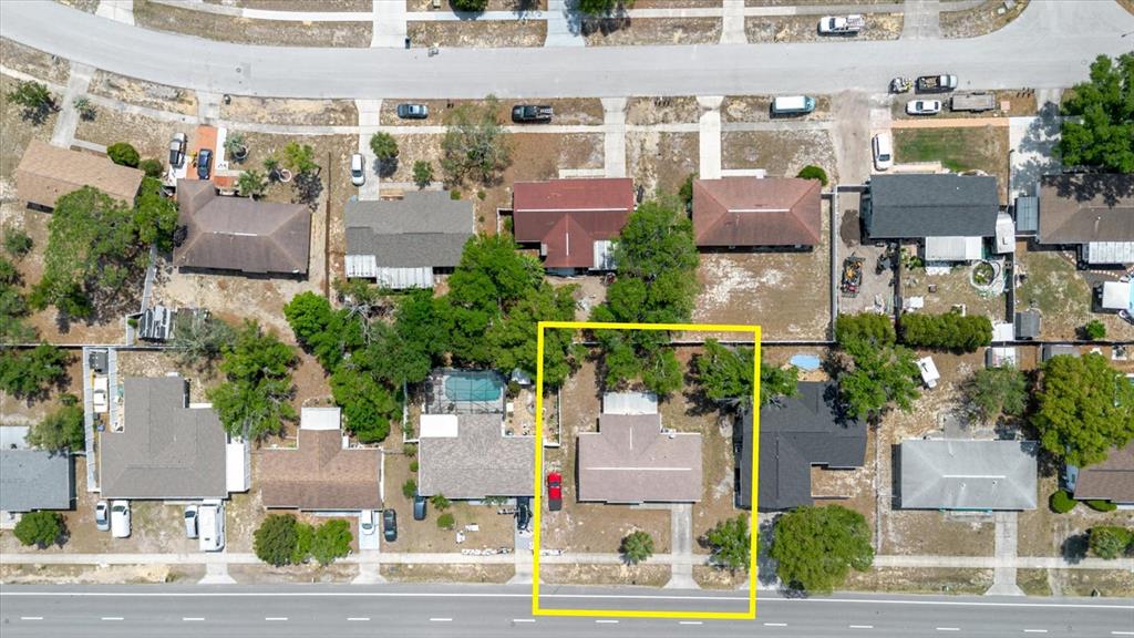 An aerial view shows a single-story house with a driveway, highlighted by a yellow border — 12526 ELGIN BOULEVARD, SPRING HILL, FL