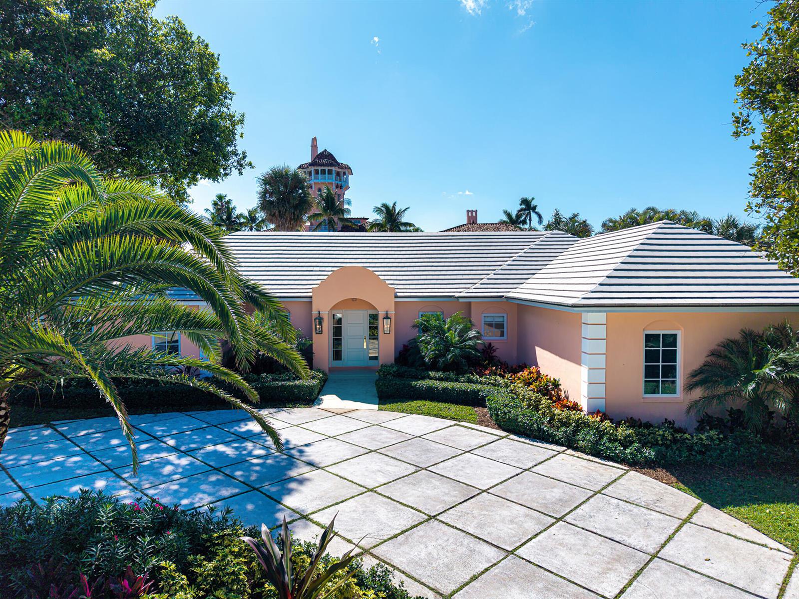 A peach-colored house with a tiled roof and a large grid-patterned concrete driveway — 124 Woodbridge Road, Palm Beach FL 33480, PALM BEACH, FL