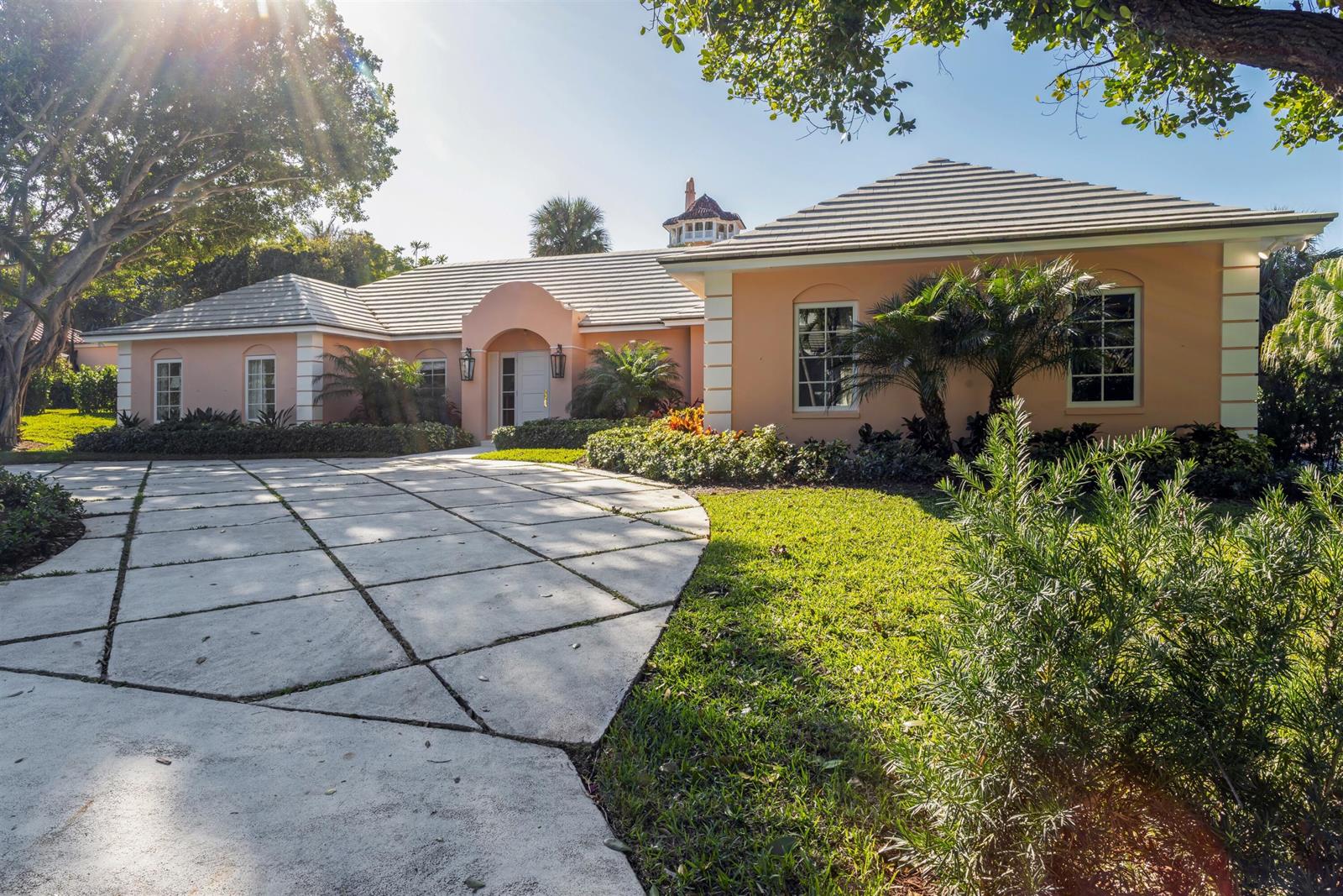A peach-colored house with a tiled roof and a large concrete driveway — 124 Woodbridge Road, Palm Beach FL 33480, PALM BEACH, FL
