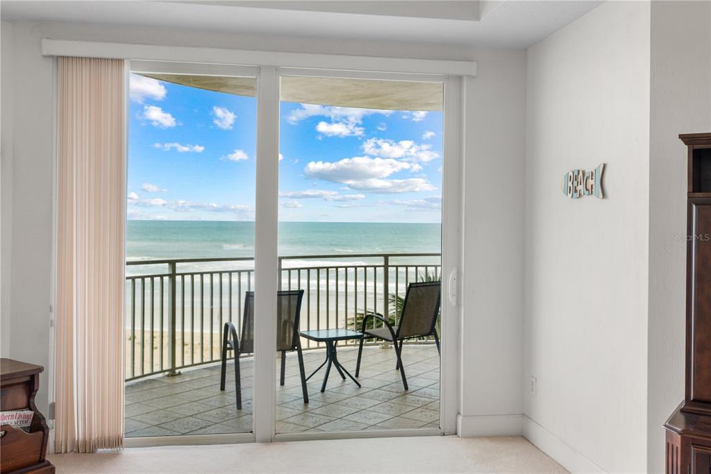 A room with a sliding glass door opening to a balcony overlooking the ocean — 2403 S ATLANTIC AVENUE UNIT 309, DAYTONA BEACH, FL