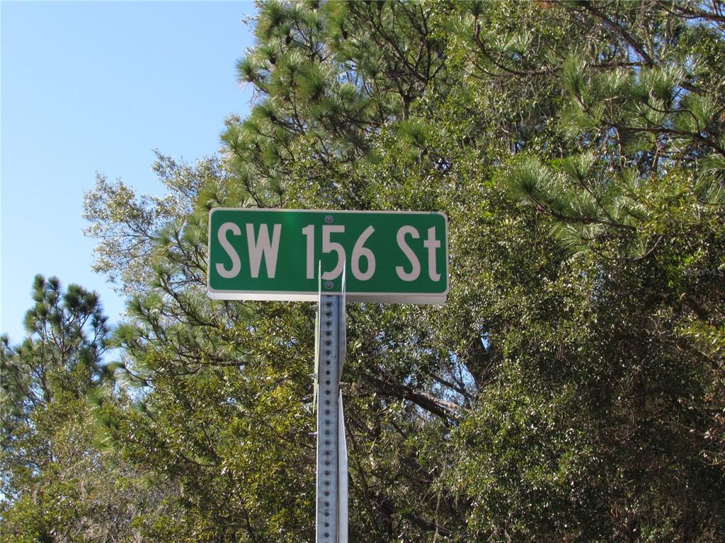 A green street sign reading SW 156 St is mounted on a metal pole — Lot 18 SW 156 STREET, OCALA, FL