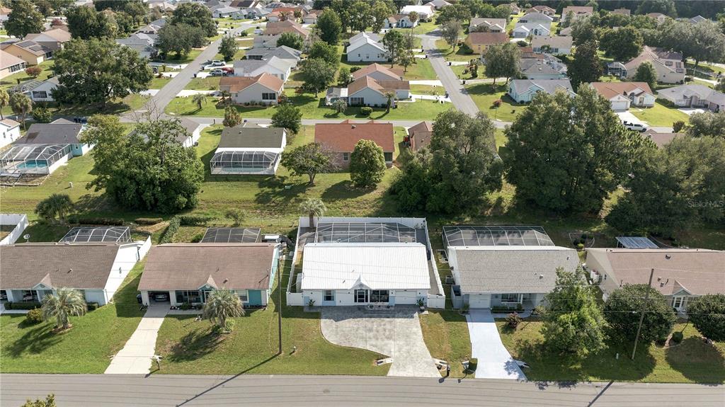 An aerial view shows a suburban neighborhood with single-family homes, driveways, and screened-in pools — 735 W STARJASMINE PLACE, BEVERLY HILLS, FL