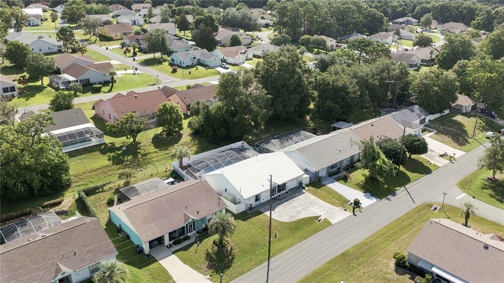An aerial view shows several suburban houses with swimming pools and driveways in a neighborhood — 735 W STARJASMINE PLACE, BEVERLY HILLS, FL
