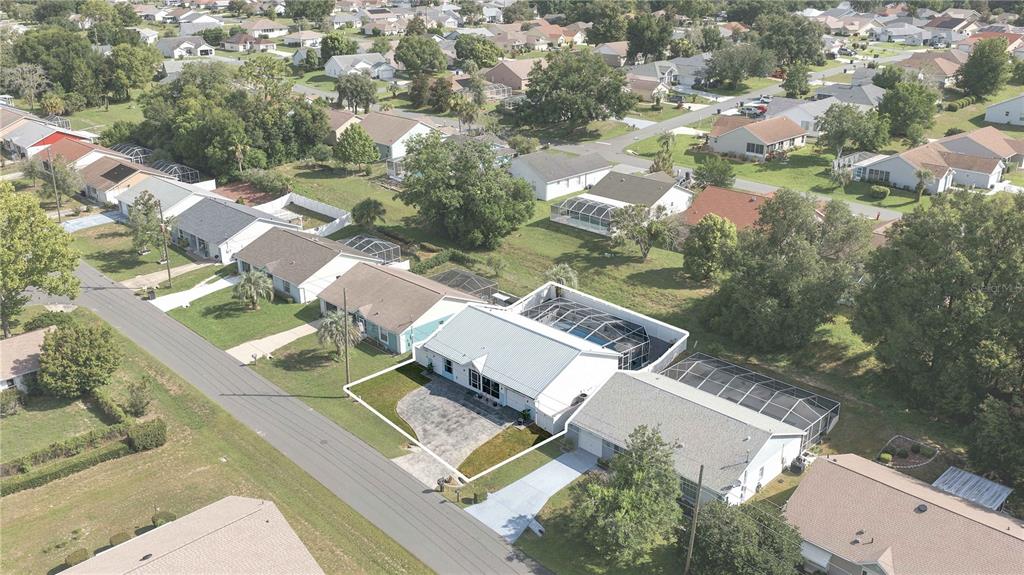 An aerial view shows a residential neighborhood with a highlighted single-story house and pool enclosure — 735 W STARJASMINE PLACE, BEVERLY HILLS, FL
