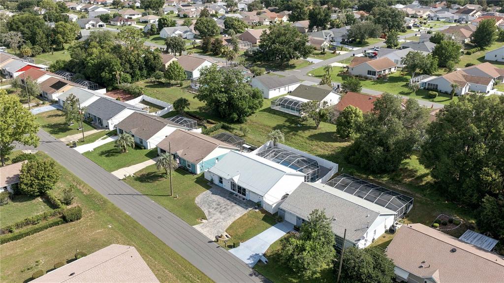 An aerial view shows a suburban neighborhood with single-family homes, driveways, and screened-in pools — 735 W STARJASMINE PLACE, BEVERLY HILLS, FL