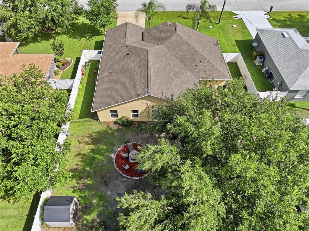 An aerial view shows a house with a brown roof, a fenced backyard, and landscaping — 10 LARKSPUR WAY, PALM COAST, FL