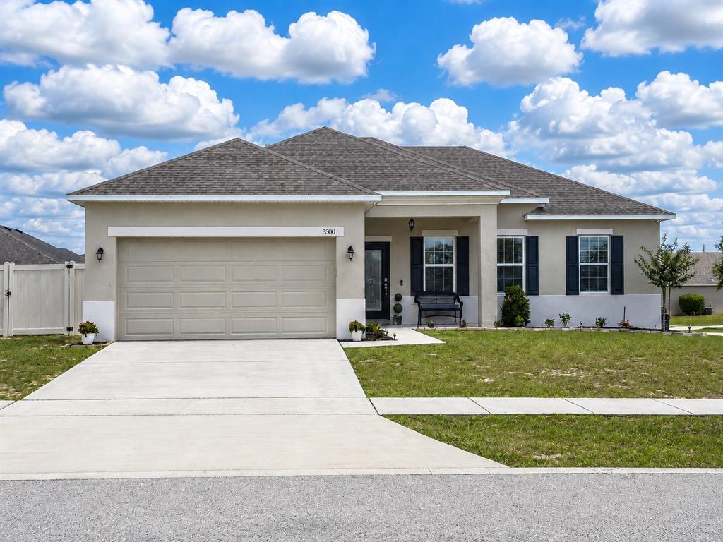 An aerial view of a single-story suburban house with a tan stucco exterior and roof — 3300 LYNROCK AVENUE, DUNDEE, FL