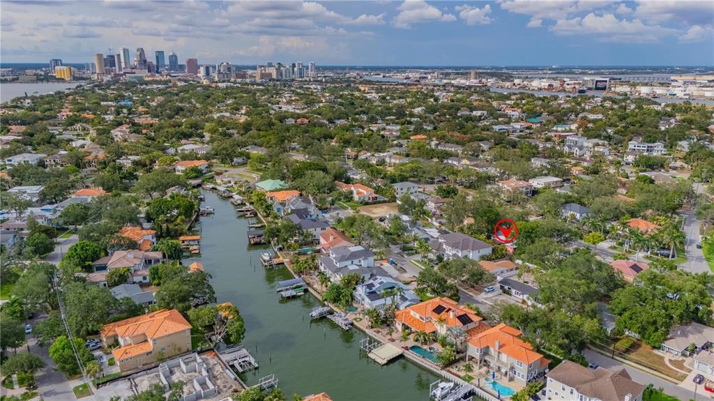 An aerial view of a waterfront neighborhood with a red circle highlighting a specific house — 504 W DAVIS BOULEVARD, TAMPA, FL